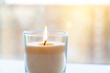 aroma candle that burns on a background of sunlight