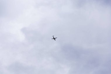 bottom view, a black passenger plane taking off or landing against a bright blue sky. Aerospace industry or tourism industry.
