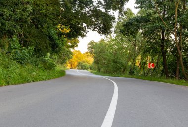 Road markings, white lines on the road. Empty two-lane.