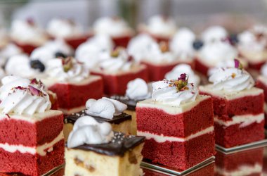 Velvet dessert of red color is arranged for presentation, dessert party.