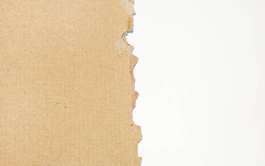 Yırtık bir karton kutunun yakın plan görüntüsü. Metin için boşluk var. Soldaki beyaz arkaplanda.