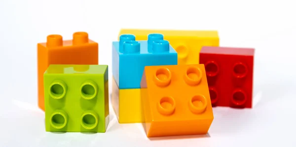 Child development, hand motor skills, colorful blocks of a childrens constructor