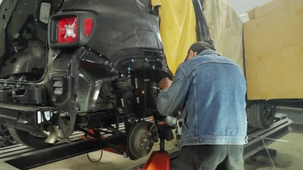 Αγνώριστος μηχανικός με συγκόλληση σε γκαράζ, επισκευή αμαξώματος, ανάκτηση — Αρχείο Βίντεο