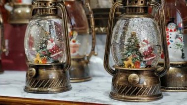 Santa claus in a glass ball with snow, Christmas Fair market, New Years decoration close-up
