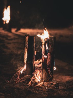 Ateşin alevlerinden çıkan duman ve tepedeki oyuklardan dikey olarak yanan tahta bir direk, böylece ateş odunları daha iyi yakar.