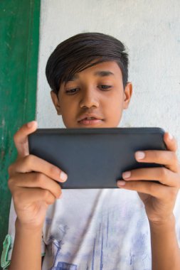 Akıllı telefonda tek başına oynayan çocuk.