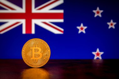 Arka planda Yeni Zelanda bayrağı olan Altın Fiziksel Bitcoin