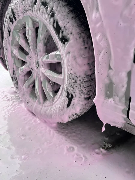 Car wash with color soap. Pink foam for washing the car. Colored foam. High quality photo