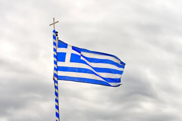 Державний прапор Греції виглядає як 9 білих і синіх смуг з хрестом на тлі сірого хмарного неба.. — стокове фото