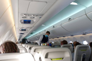 Passengers traveling by plane, inside of an airplane. steward serving food and drinks. close up