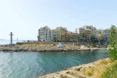A view of coast sea and greek houses background. Colorful Mediterranean architecture on a sunny clear day. close up