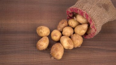 Tahta masada pişirmek için taze patates.