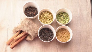 Indian Spices and herbs on wooden background. Food and cuisine ingredients.