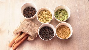 Indian Spices and herbs on wooden background. Food and cuisine ingredients.