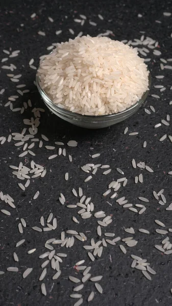 Uncooked raw rice in glass bowl. Healthy food concept. Copy space