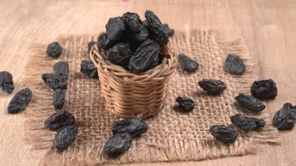 Closeup Wicker Basket Dried Black Dates Wooden Table — Stock Photo, Image