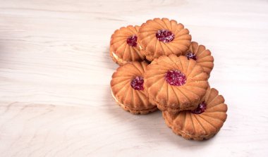Tatlı reçelli bisküvilerin en üst görüntüsü. Sandviç bisküvileri veya ahşap arka planda kremalı bisküviler. 