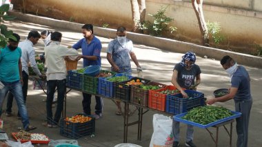 INDIA - 08 Mayıs 2020: Gündüz sebze pazarı ile sokakta duran kalabalık  