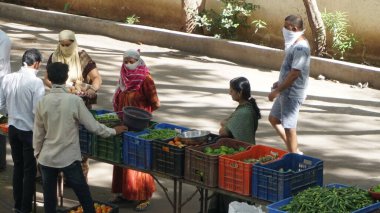 INDIA - 08 Mayıs 2020: Gündüz sebze pazarı ile sokakta duran kalabalık  