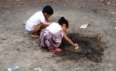 INDIA - 03th FEBRARY, 2020: Hintli çocuklar gündüz vakti su birikintisiyle oynuyorlar 