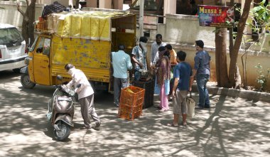 INDIA - 08 Mayıs 2020: Kalabalık gündüz vakti arabanın etrafında sebzelerle dikiliyor