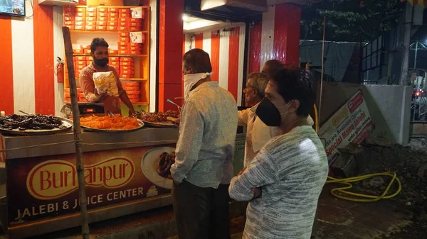 INDIA - 15 EKİM 2021: Geceleyin gıda pazarına yakın duran kalabalık