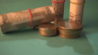 Coins and Rolled Indian Currency closeup, money saving financial concept, Money Growth.