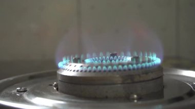 Gas burns in an old kitchen stove, closeup, slow motion 