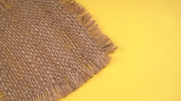 Close Burlap Fabric Napkin Yellow Background — Zdjęcie stockowe