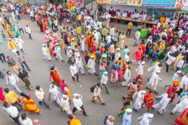PUNE, MAHARASHTRA, INDIA - 24 HAZİRAN 2022: Pandharpur savaş alayı yolcuları Vitthala tapınağına doğru dans ederek dini şarkılar söyleyerek yürürken.