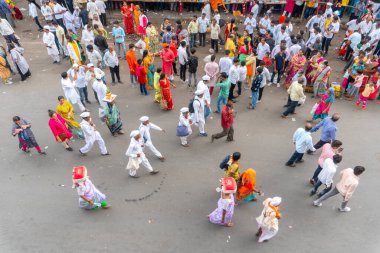 PUNE, MAHARASHTRA, INDIA  - 24TH JUNE, 2022: During Pandharpur wari procession Pilgrims marching towards Vitthala temple with singing religious song with dancing.