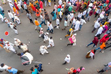 PUNE, MAHARASHTRA, INDIA  - 24TH JUNE, 2022: During Pandharpur wari procession Pilgrims marching towards Vitthala temple with singing religious song with dancing.
