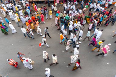 PUNE, MAHARASHTRA, INDIA - 24 HAZİRAN 2022: Pandharpur savaş alayı yolcuları Vitthala tapınağına doğru dans ederek dini şarkılar söyleyerek yürürken.