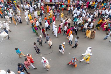 PUNE, MAHARASHTRA, INDIA  - 24TH JUNE, 2022: During Pandharpur wari procession Pilgrims marching towards Vitthala temple with singing religious song with dancing.