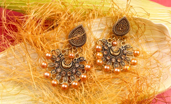 Beautiful Gold Earrings Corn Plant Red Background — 스톡 사진