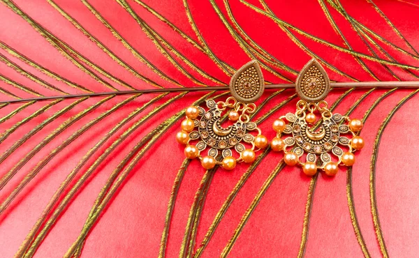 Beautiful Gold Earrings Red Background — Stockfoto