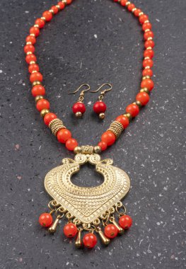 Beautiful traditional indian necklace and earrings in heart form on silver background