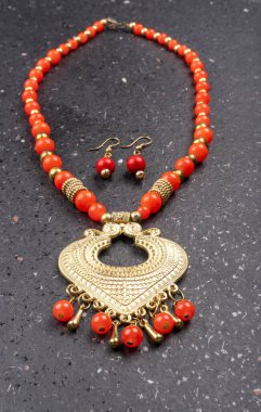 Beautiful traditional indian necklace and earrings in heart form on silver background