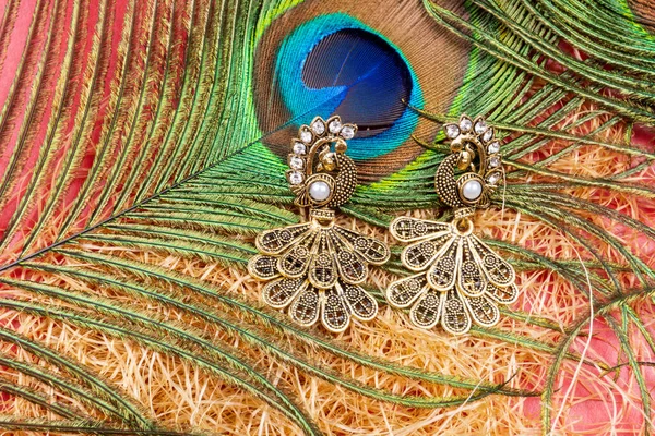 Beautiful Earrings Peacock Feather Red Background —  Fotos de Stock