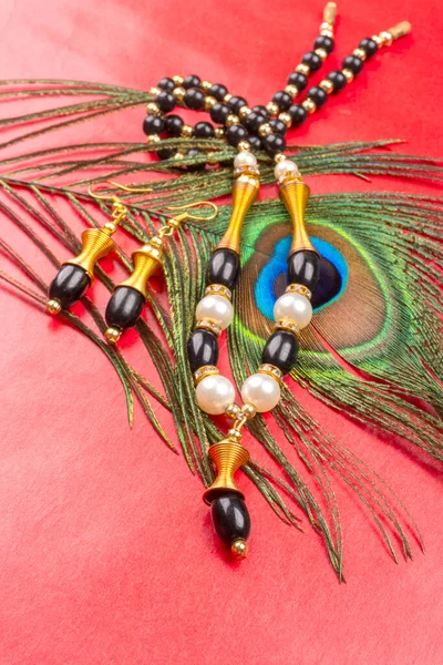 Beautiful Beads Peacock Feather Red Background —  Fotos de Stock