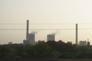 Landscape with power station on background at sunset 