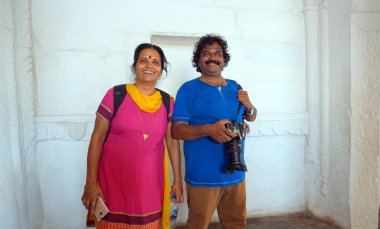 Adult smiling Indian couple looking away