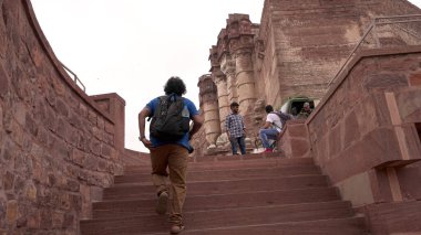 People in ancient castle or temple in India