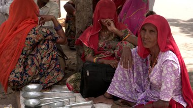 Indian women selling kitchen utensils outdoors