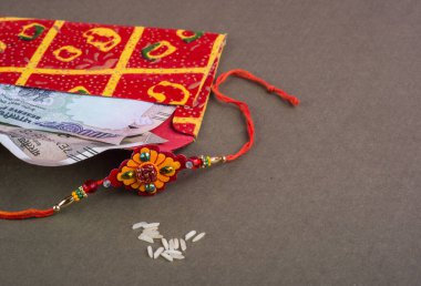 Traditional Indian jewelry with rice and money banknotes