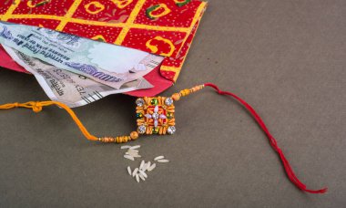 Traditional Indian jewelry with rice and money banknotes