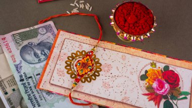 Traditional Indian jewelry with money, rice, spice and greeting card
