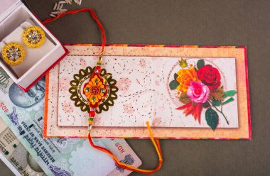 Traditional Indian jewelry and earrings with rice, spice and greeting card