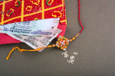 Traditional Indian jewelry with rice, envelope and money banknotes
