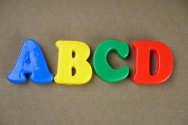 ABCD letters on brown background  